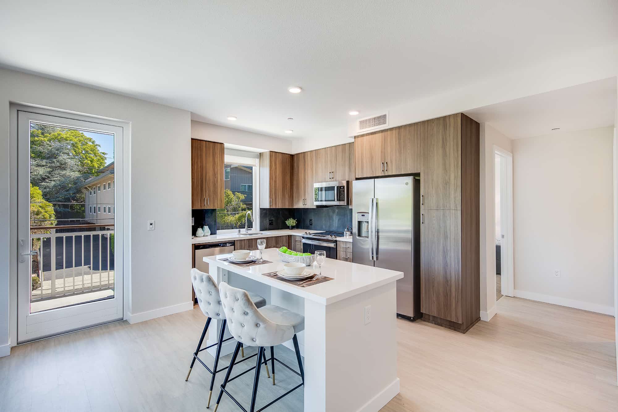 Luxury Apartments for Rent in Menlo Park - Realm - Modern Kitchen With Appliance Suite, Spacious Wooden Cabinets, and Nearby Dining Area